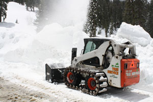 Small tractor clearing snow